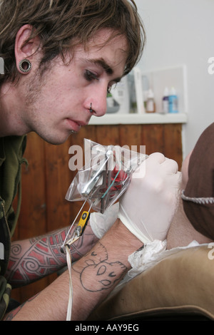 A tattoo artist at work. Stock Photo