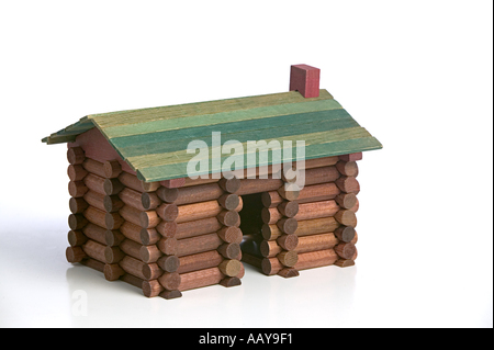 Still Life of log cabin contruction toy made from vintage Lincoln Logs circa 1960 on a white background Stock Photo