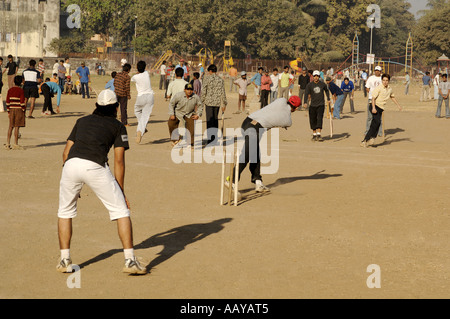 HMA78727 Indian boys playing cricket on playground Bombay Mumbai Maharashtra India Stock Photo