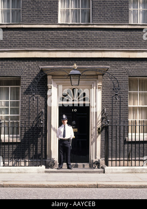 Number 10 ten Downing street front door and duty police officer Westminster London England UK Stock Photo