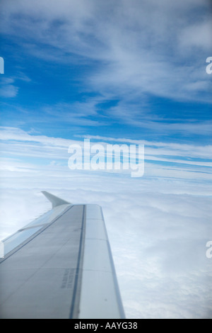 Wing of plane in sky and white clouds Stock Photo - Alamy