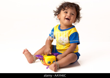 Asian Kid With Curly Hair Looking Pose When Being Photographed With Bright Emotions Smiling Stock Photo Alamy