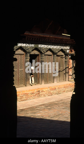 An old man seen through a doorway in Bhaktapur, Kathmandu, Nepal. Stock Photo