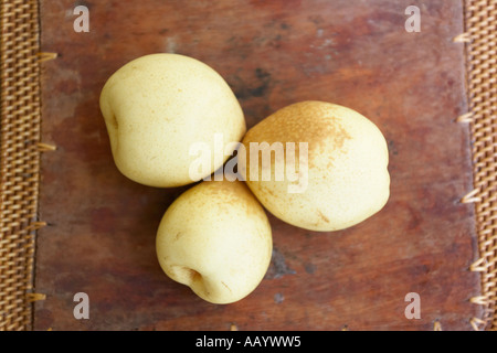 Three Chinese pears on a wooden tray. Stock Photo