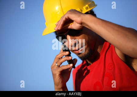 Construction worker talking on cell phone Stock Photo