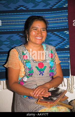 Lady with wool combing tools used in hand made carpet manufacture, Teotitlan del Valle, near Oaxaca, Oaxaca State, Mexico Stock Photo