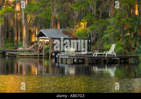 A boat house and dock in a golden sunset at Lake Rousseau near Dunnellon and Crystal River, Florida, USA Stock Photo