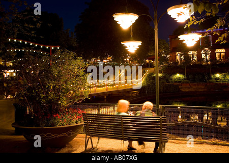 Two people enjoying the summer night at the lake in Tivoli Copenhagen Stock Photo