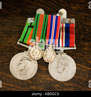 WW2 British Service Campaign war medals with smaller versions for wearing on a lapel Stock Photo