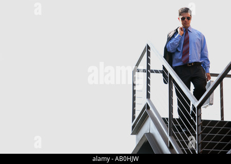 Businessman walking down stairs Stock Photo