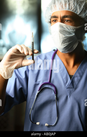 Doctor with syringe in hand Stock Photo
