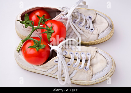 Dirty sneakers and tomatoes Stock Photo