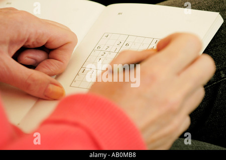 Person playing the number game SUDOKU Stock Photo