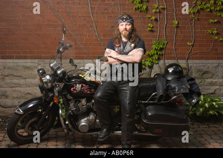 Bandana Motorcyclist, black leather jacket and tattoos Stock Photo