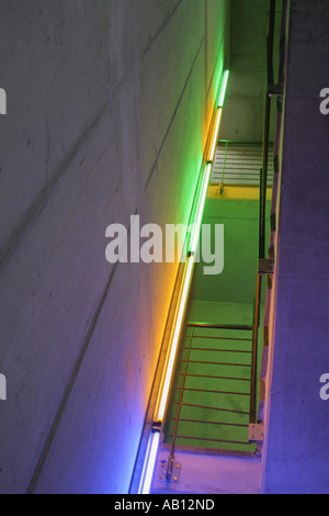 Modern office staircase lighting building creating an eerie atmosphere with coloured Neon light Stock Photo