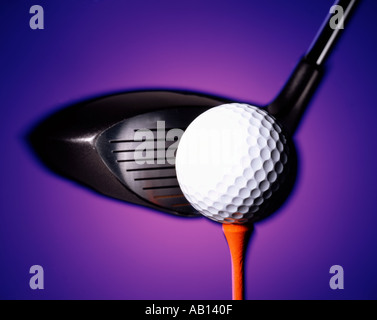 golf ball sitting on tee driver striking ball on purple background Stock Photo