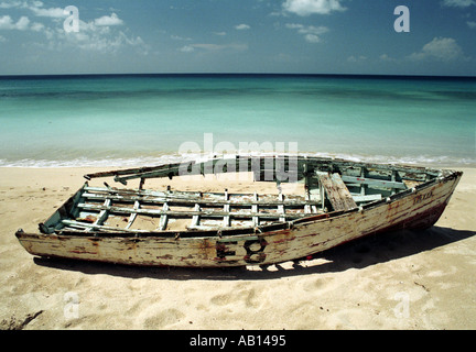 A wreck of a rowing boat on a beach at Holetown Barbados Stock Photo