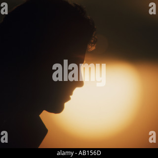 young man in pensive mood at sunset Stock Photo