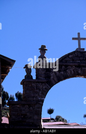 Statues on archway on the rocky altiplano island of Isla Taquile Lake Titicaca Peru Stock Photo
