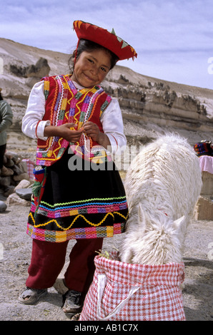 Andean girl and alpaca at rest stop in the Reserva Nacional Salinas y Aguada Blanca Colca Canyon Peru Stock Photo