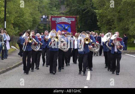 Workers and their families march under trade union banners and led by a brass band from Corus Ebbw Vale tinplate works Wales UK Stock Photo