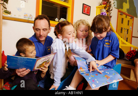 Fathers reading to pupils at after school club in Rhondda Valley South Wales UK GB EU Stock Photo