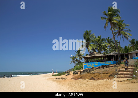Light coloured sand palms and beach cafe Anjuna Beach Goa India Stock Photo