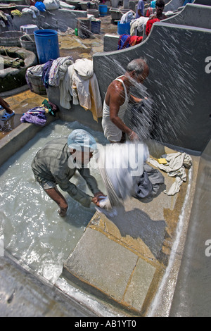 Dhobi wallahs pounding washing at dhobi ghats outdoor laundry Banganga Bombay Stock Photo