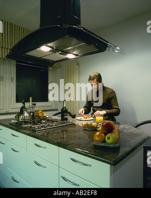 Man enjoying dinner in a kitchen Stock Photo