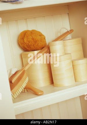 Interior detail bathroom cupboard containing natural sponge brush and containers Stock Photo