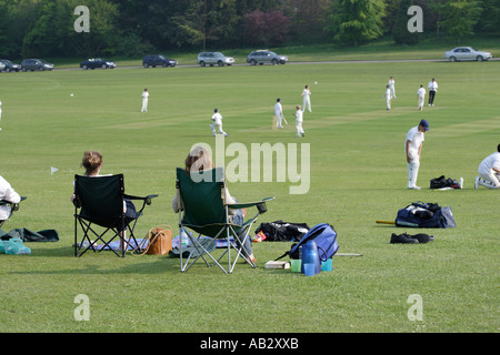 Mothers watching their boys school cricket match Stock Photo