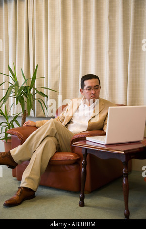 Mature man using computer Stock Photo