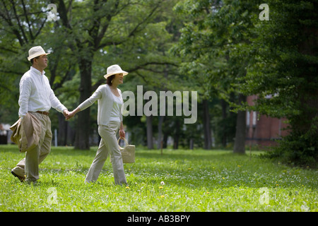 Mature couple walking holding hands Stock Photo