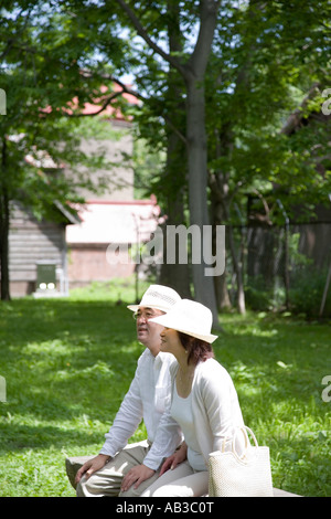 Mature couple sitting on bench Stock Photo