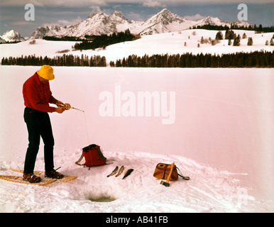Sawtooth National Recreation area of Idaho showing a Winter fisherman on snowshoes on a frozen lake Stock Photo