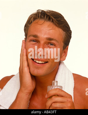 Man using aftershave lotion Stock Photo