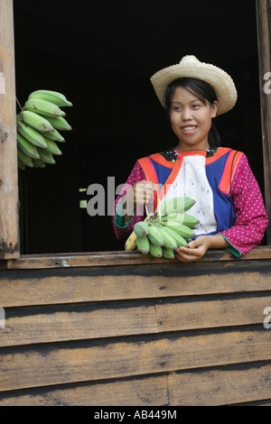 Girl selling bananas to tourists on an elephant treck in Northen  Thailand, near Chang Mai Stock Photo