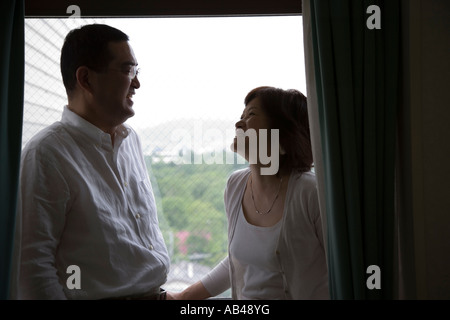 Mature couple standing on balcony Stock Photo