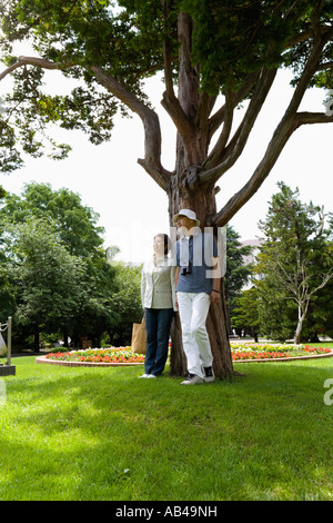 Senior couple standing under tree Stock Photo