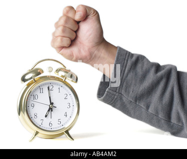 A fist punching an alarm clock Stock Photo - Alamy