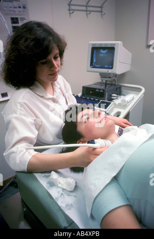 Carotid Duplex is performed on a patient to check for blockage of the carotid artery during a routine examination Stock Photo