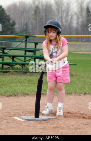 5 year old boys and girls learn how to play baseball by participating in a T ball league for tots Stock Photo