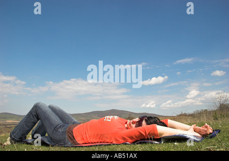 Young woman lying on grass spring Stock Photo