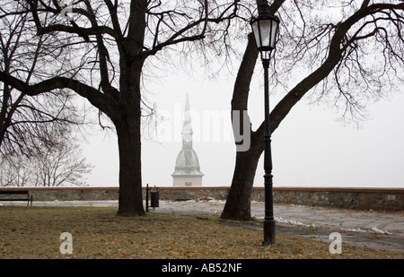 Spire of St Martins Cathedral in the mist viewed from Bratislava Castle Stock Photo