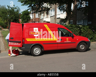 Essex Royal Mail Vauxhall combo 1 7Di van parked postman at rear of van sorting letters for the next part of his round Stock Photo