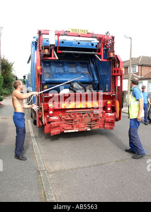 Dustmen and lorry on weekly rubbish collection Stock Photo