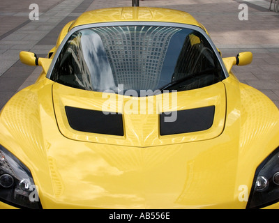 Canary Wharf outdoor Motor Show type exhibition of latest car models displayed Vauxhall VX220 with reflection of office block in windscreen London UK Stock Photo