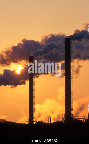 Belching smokestacks Pollution at sunset Avonmouth Avon England UK Stock Photo