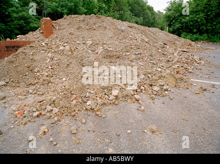 Pile of rubble dumped at a closed down garage forecourt, preventing unlawful access, Badgers Mount, Kent, England, UK. Stock Photo