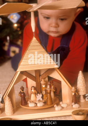 baby boy looking at a Christmas crib Stock Photo